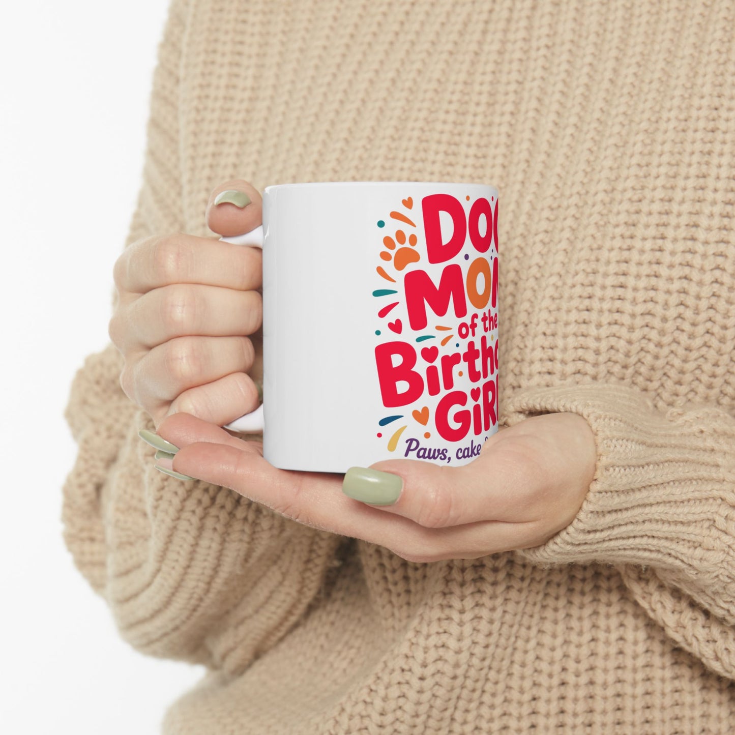 White mug held by hands, "Dog of the Birthday Girl" text with paw prints.