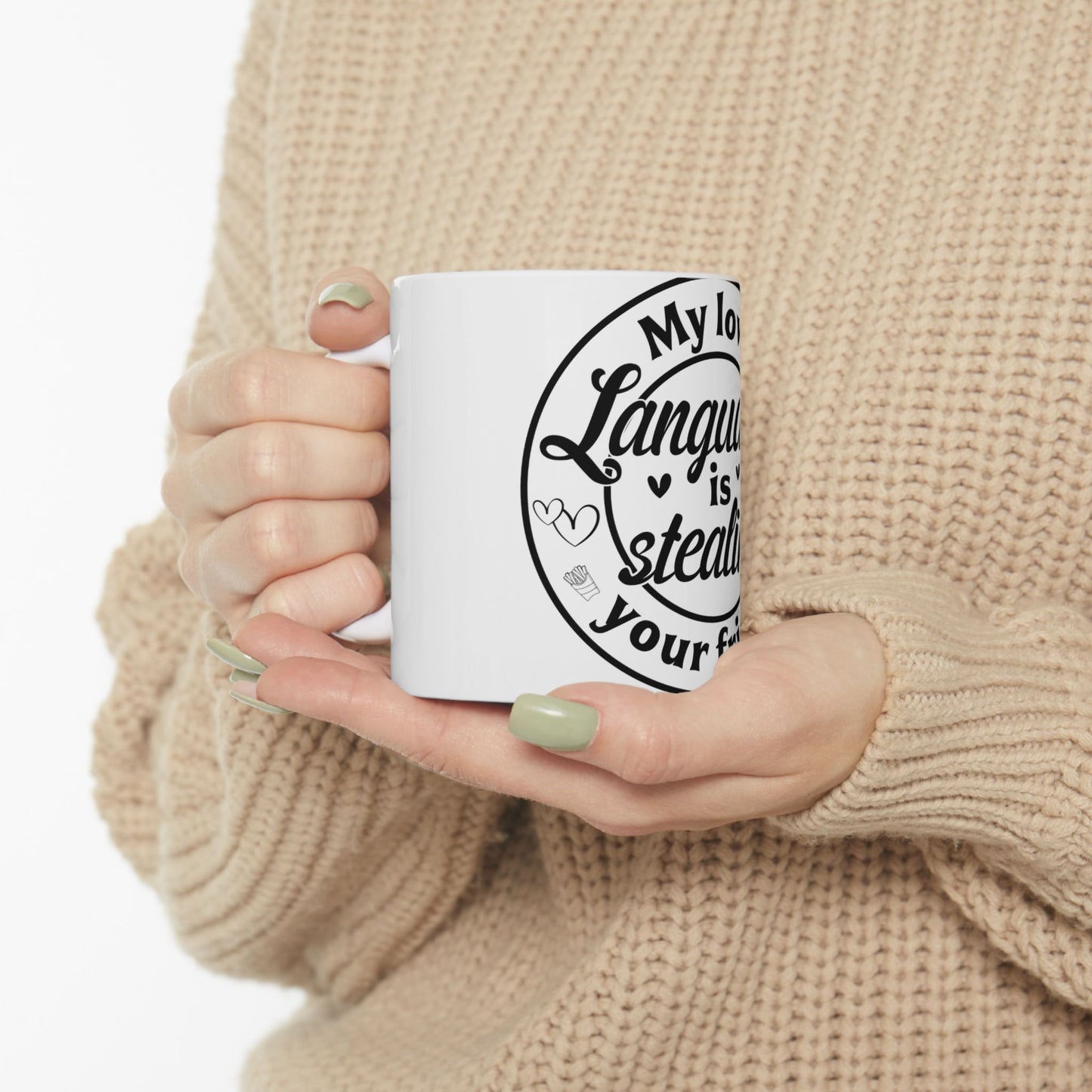White mug with "My love language is stealing your..." text and heart graphics.