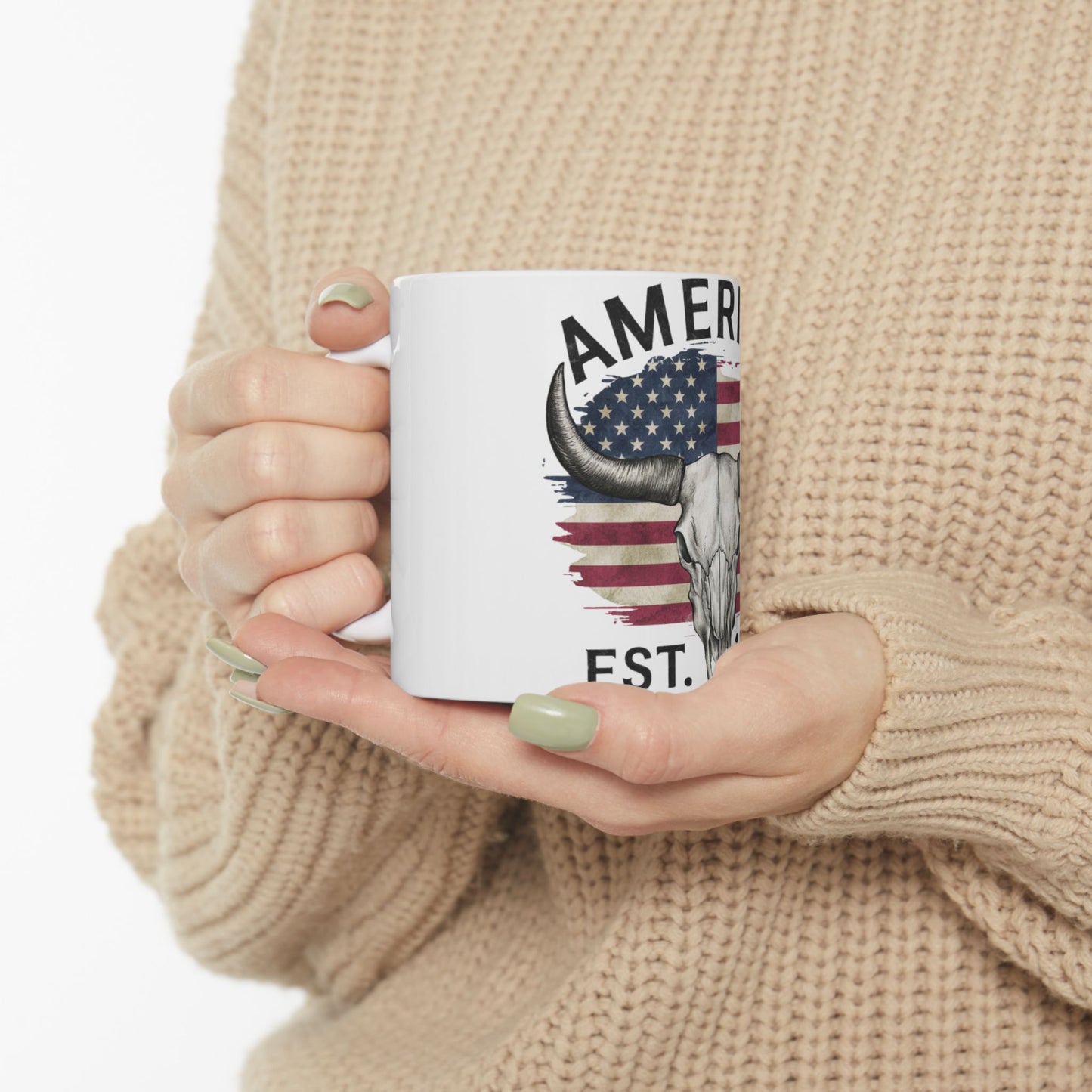 White mug with American flag skull design and "AMERICA EST." text.