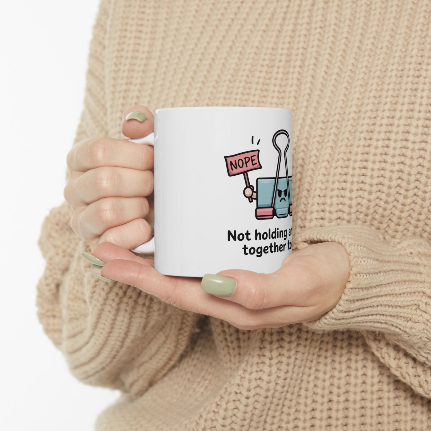 Binder clip with "Nope" sign holding together text on a white mug.