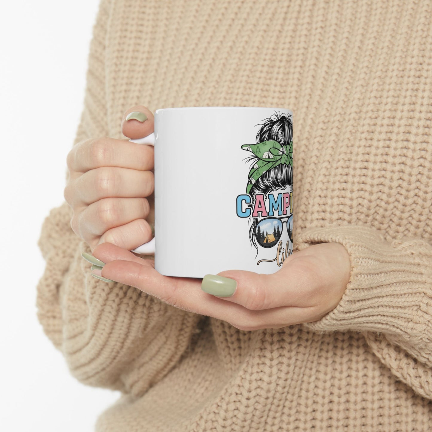 White mug with "Camping Life" text and sunglasses graphic, held by hands.