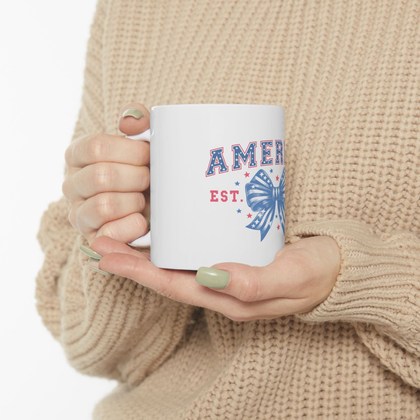 White mug with "AMER EST." and a red, white, and blue bow graphic.