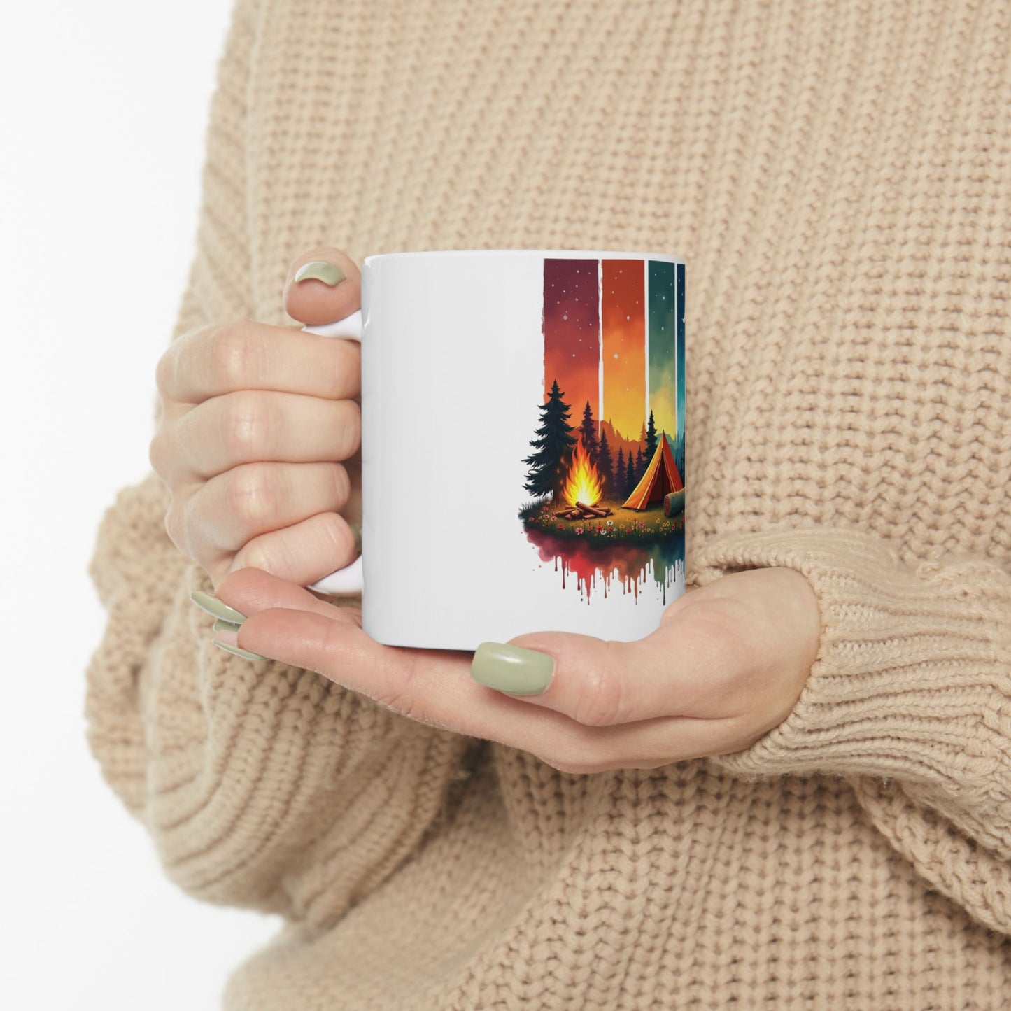 White mug with a colorful camping scene and a warm campfire.