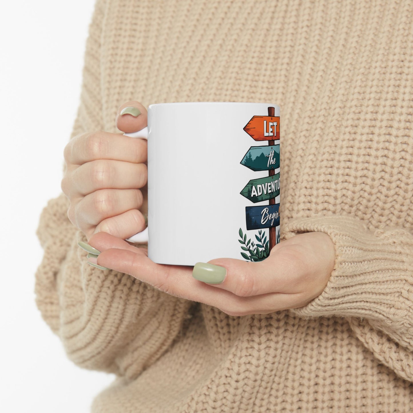 White mug with colorful directional signs saying "LET the ADVENTURE Begin".