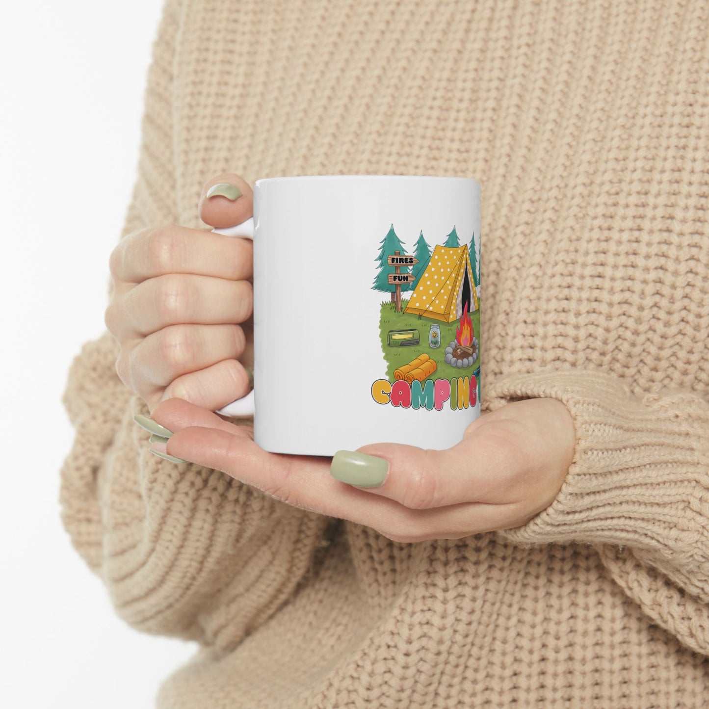 White mug with camping graphic and text "CAMPING" held by hands.
