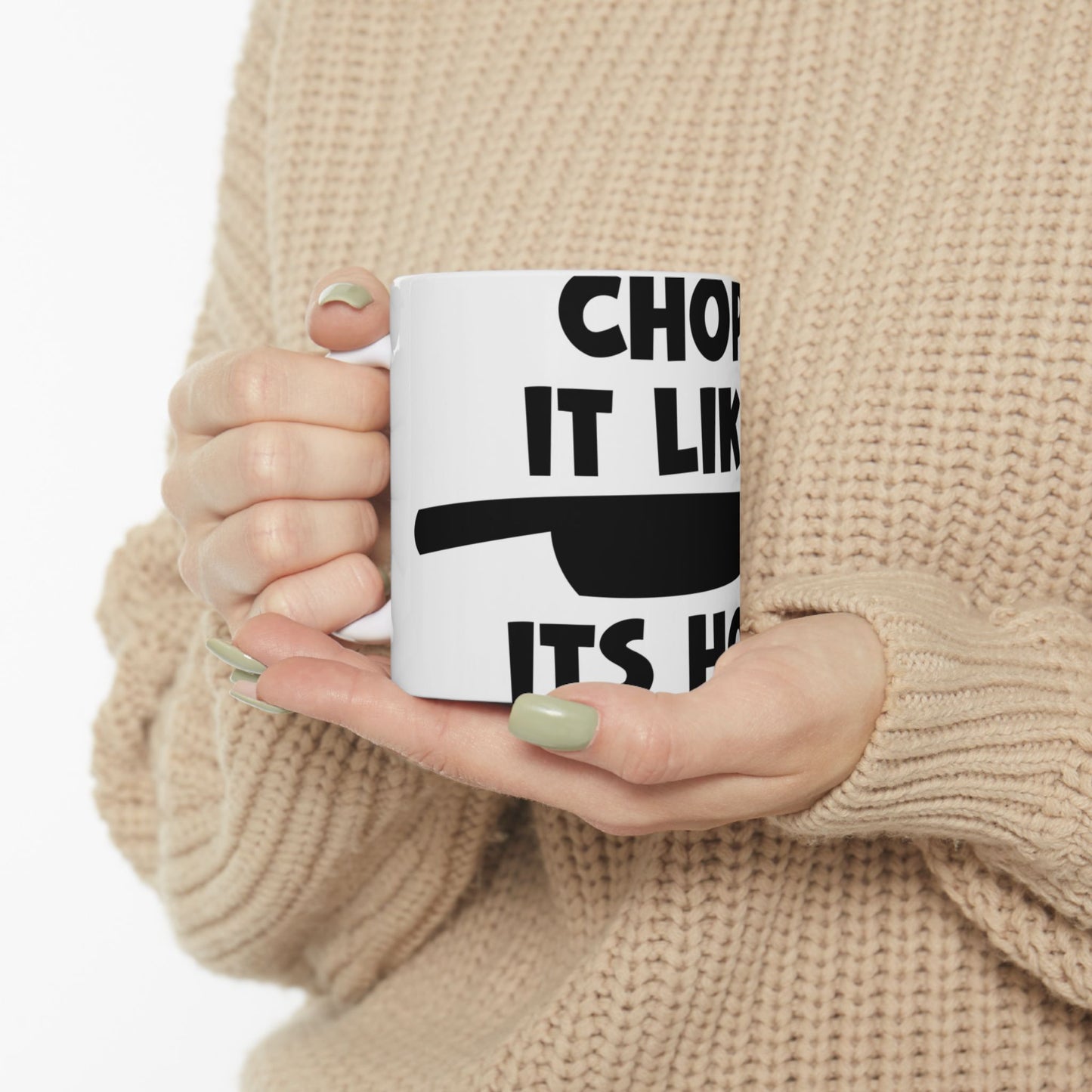 White mug with black text and knife graphic.