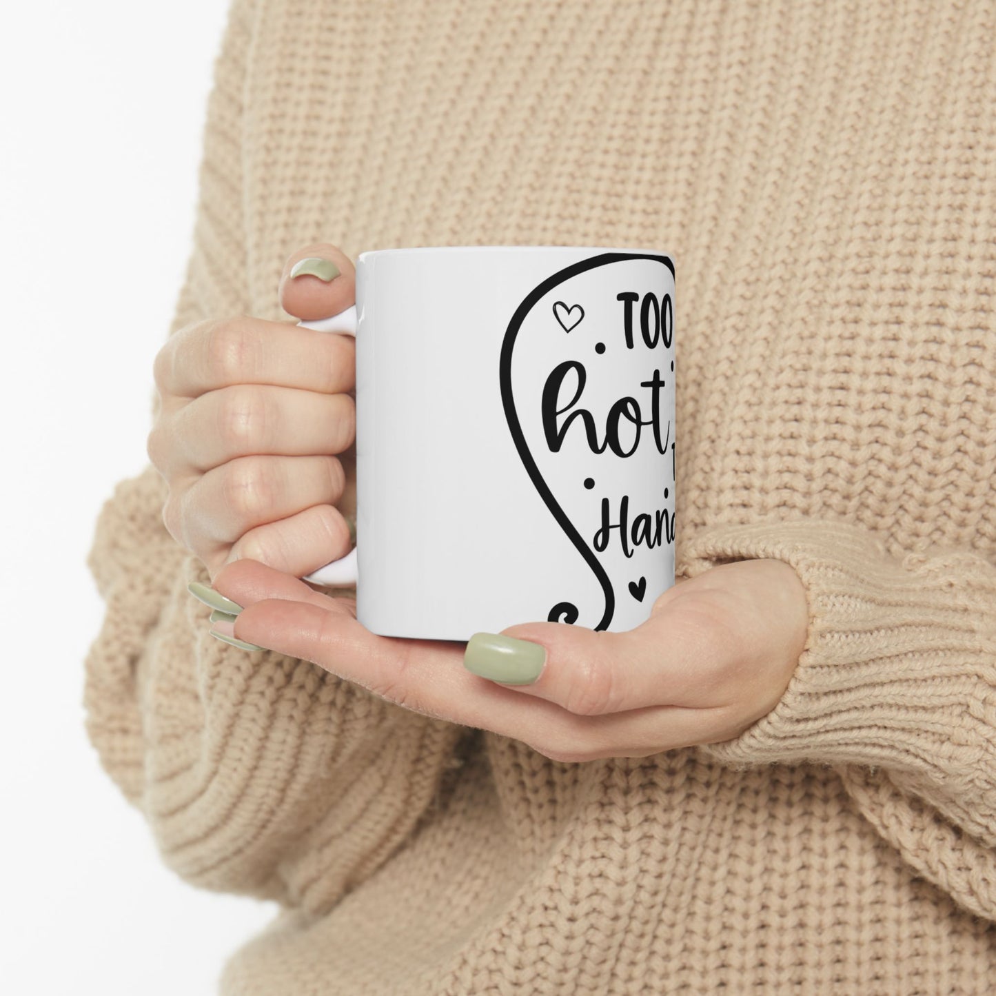 White mug held by hands, with "Too hot to handle" text.