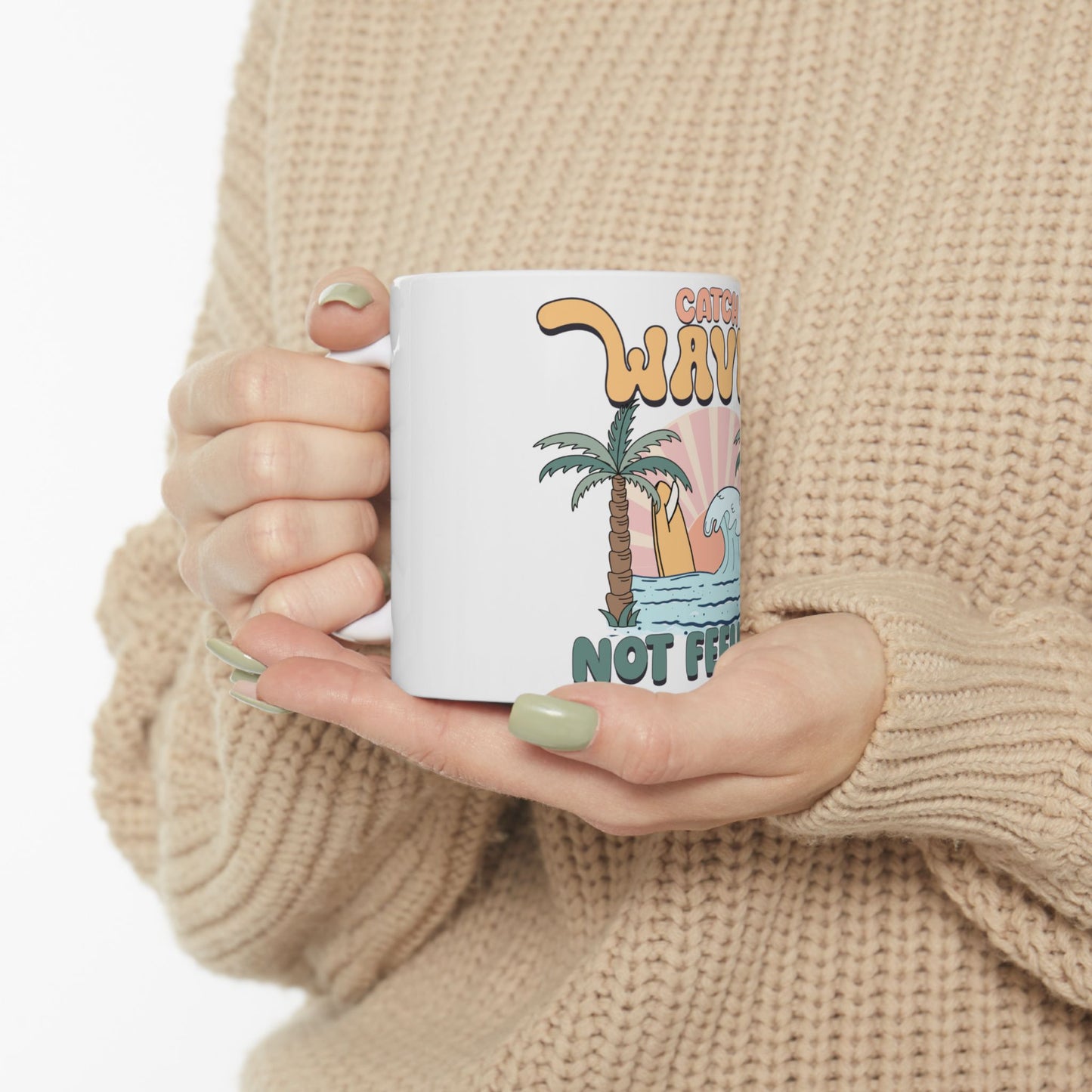 White mug with "Catch waves not feelings" and a palm tree illustration.