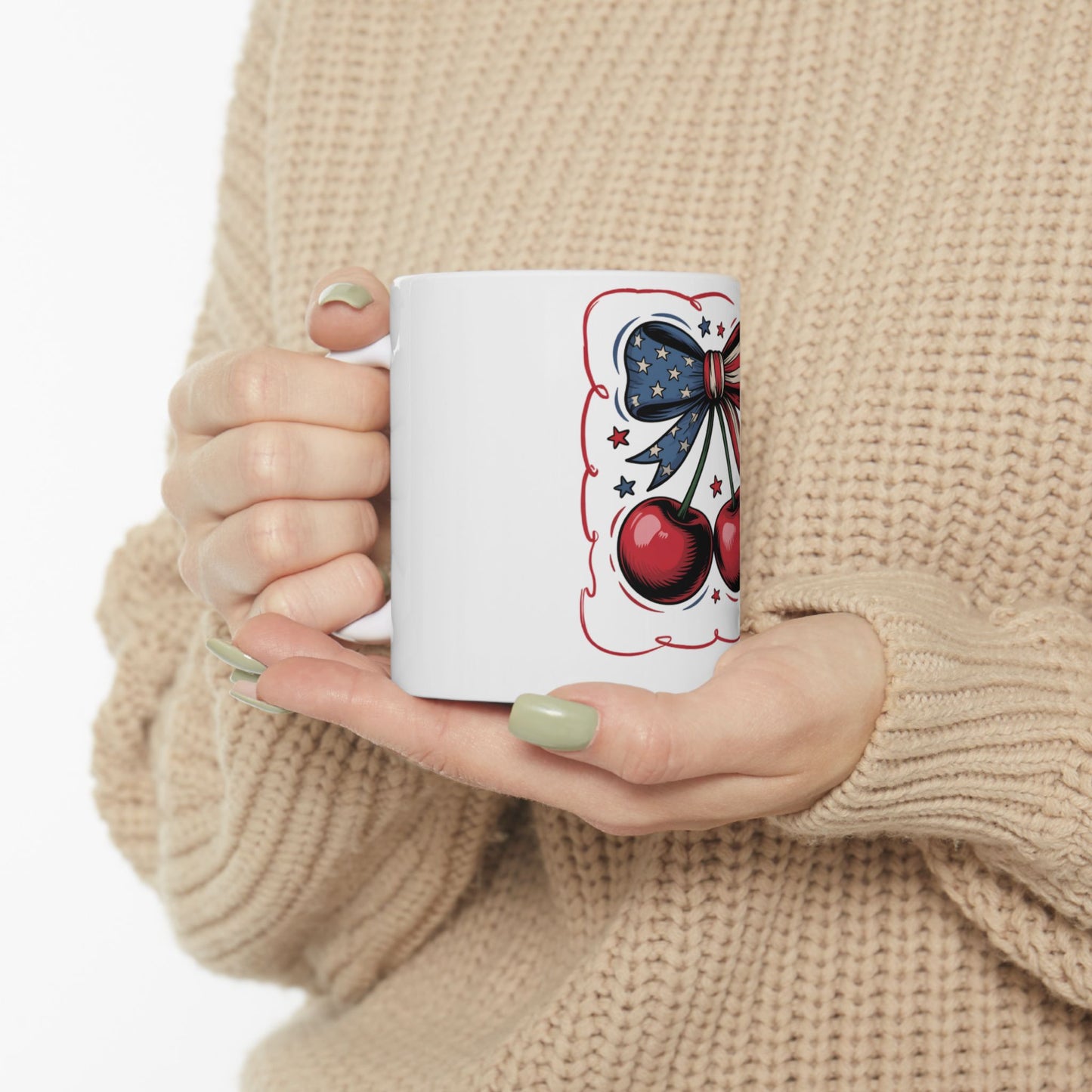 White mug with red cherries and a blue bow design.