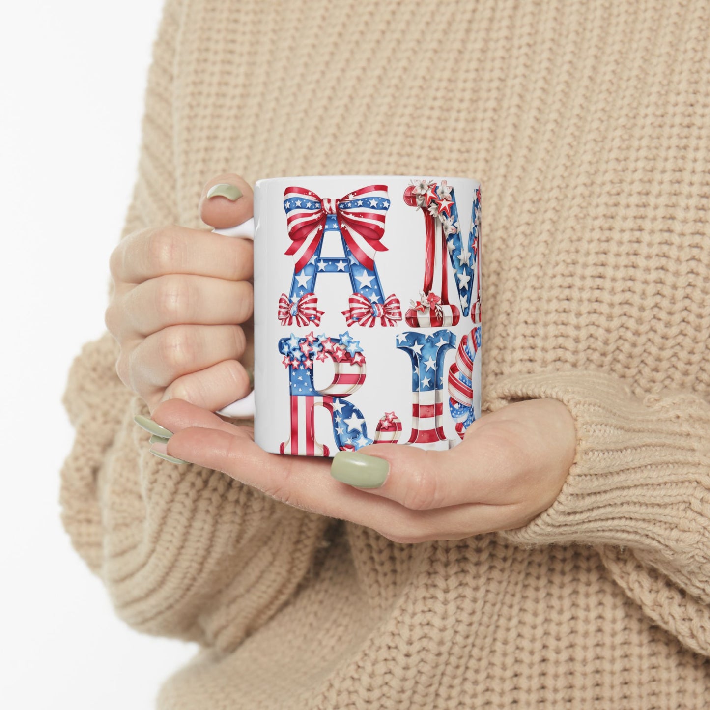 White mug with "AMERICA" in patriotic letters, held by person.