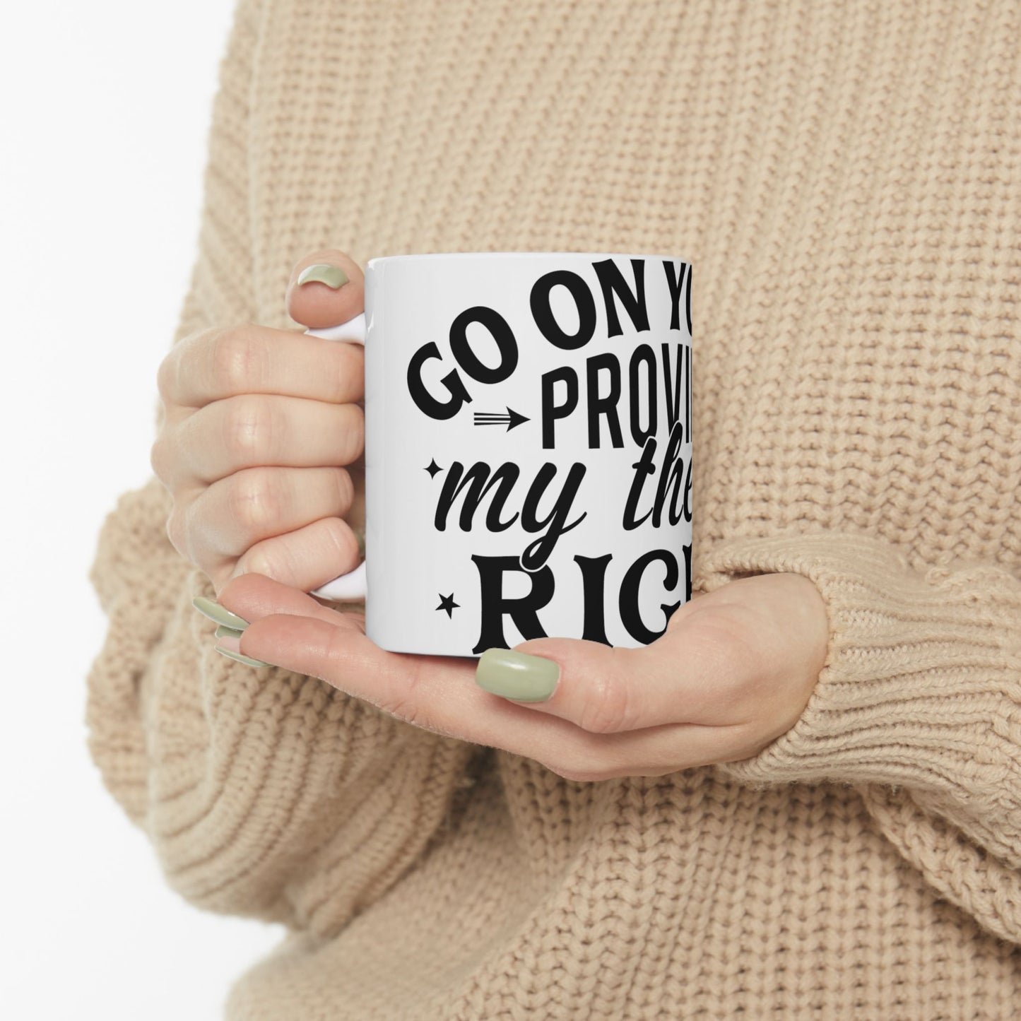 White mug with text "GO ON Y my the RIG" held by two hands.