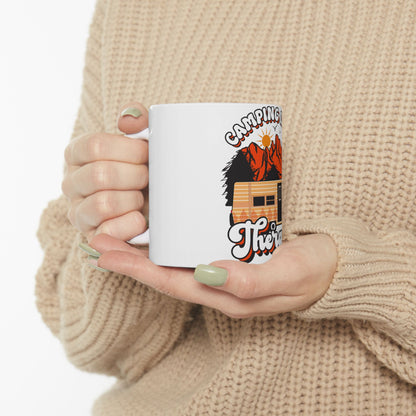 White mug with "Camping is therapy" text and a camping scene graphic.