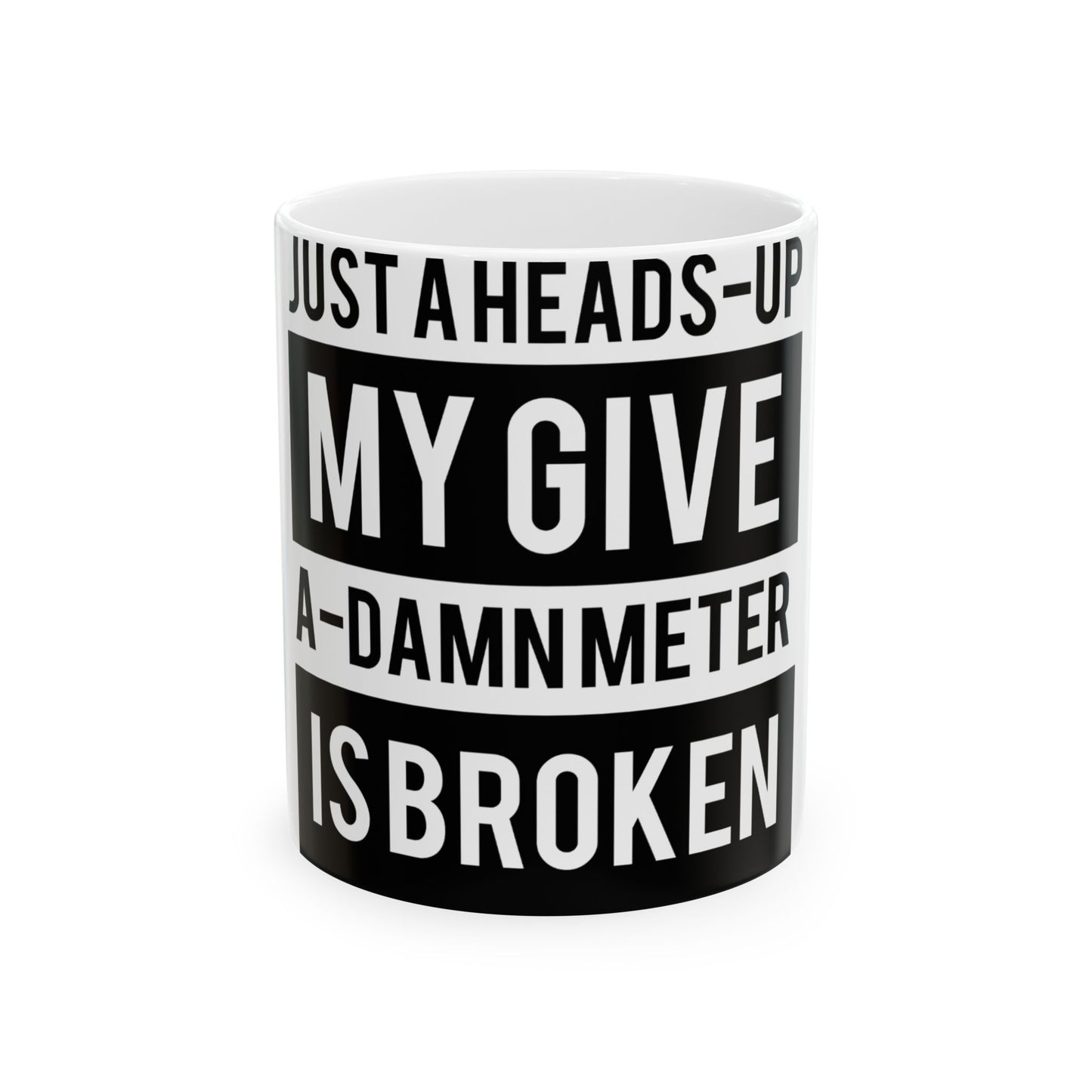 White mug with black text saying "JUST A HEADS-UP MY GIVE-A-DAMN METER IS BROKEN".