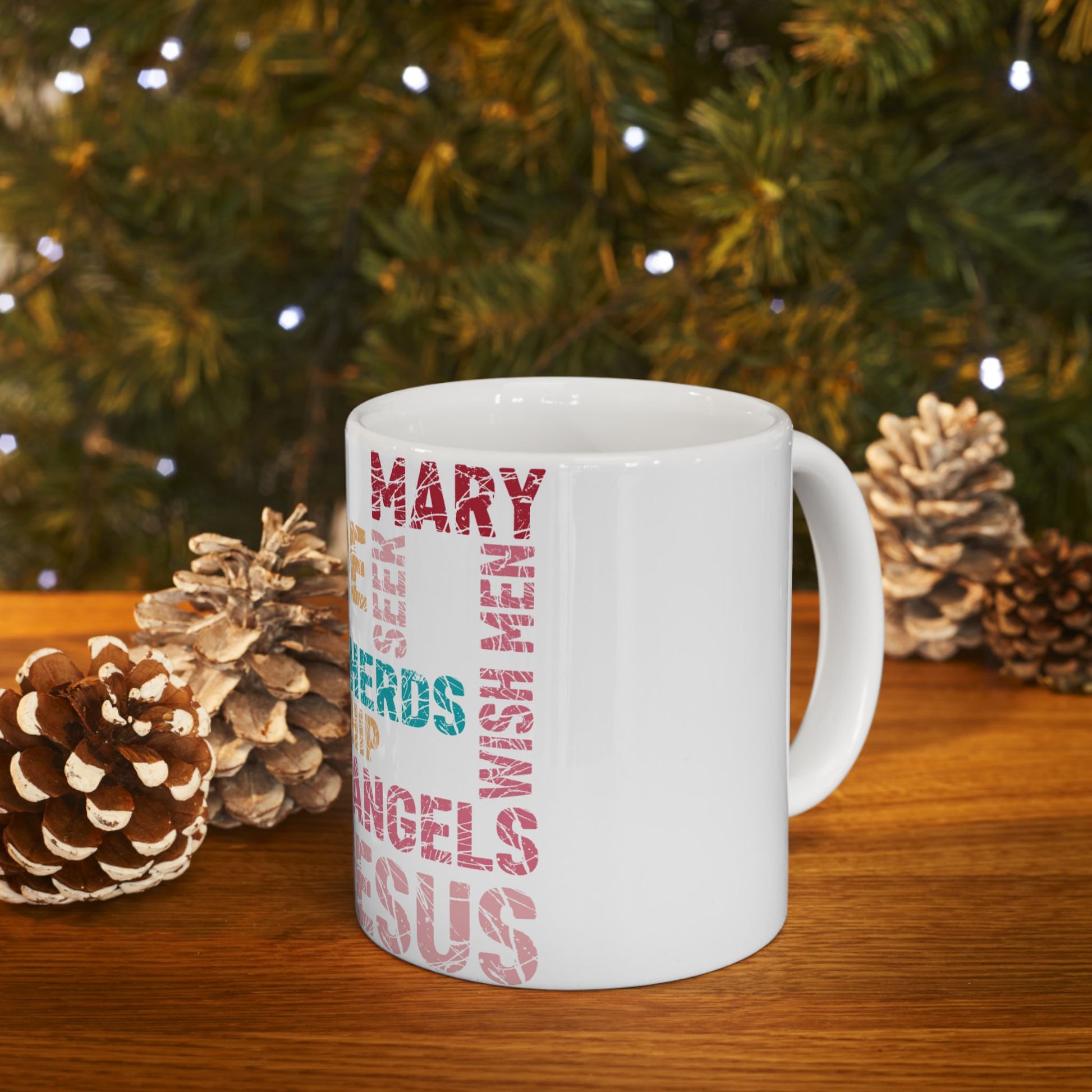 White mug with "MARY" and "ANGELS" in vertical text, on a wooden surface.