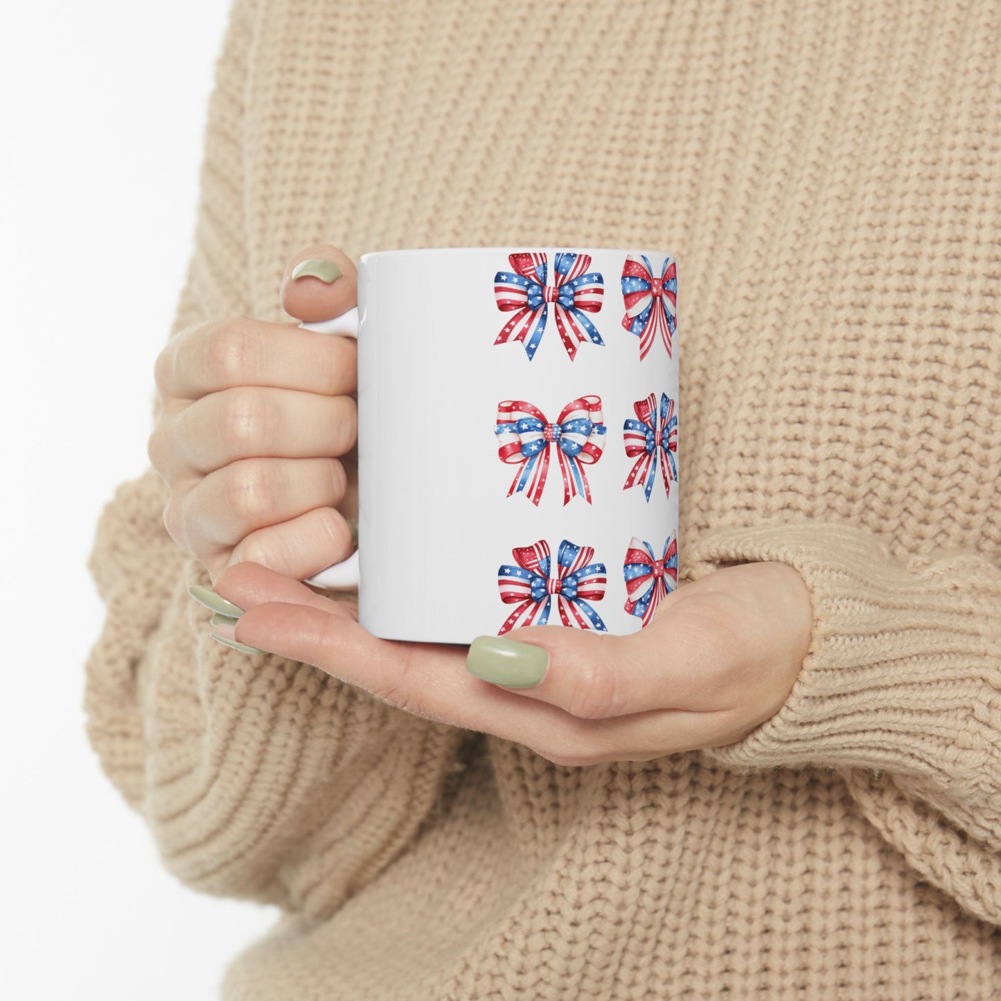 White mug with repeating patriotic bow pattern on a light background.