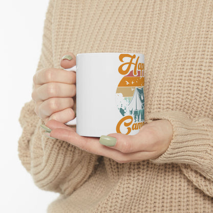 White mug with "Happy Camper" text and a camping scene graphic.