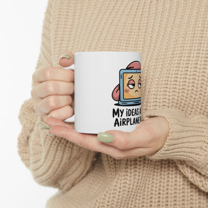White mug with cartoon computer and text "MY IDEAS ARE LIKE AIRPLANES".
