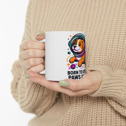 White mug with astronaut dog and "Born to Explore" text.