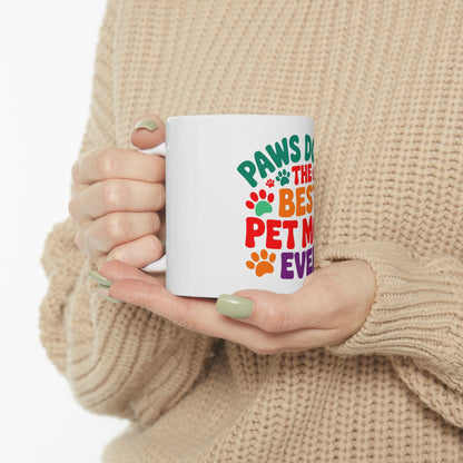White mug with "Paws are the best pet mom ever" text and paw prints.