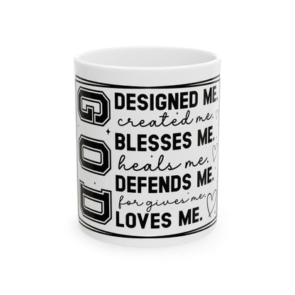 Mug with "GOD DESIGNED ME, BLESSES ME, DEFENDS ME, LOVES ME" text.