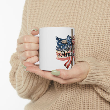White mug with American flag cross and text "God Bless America".