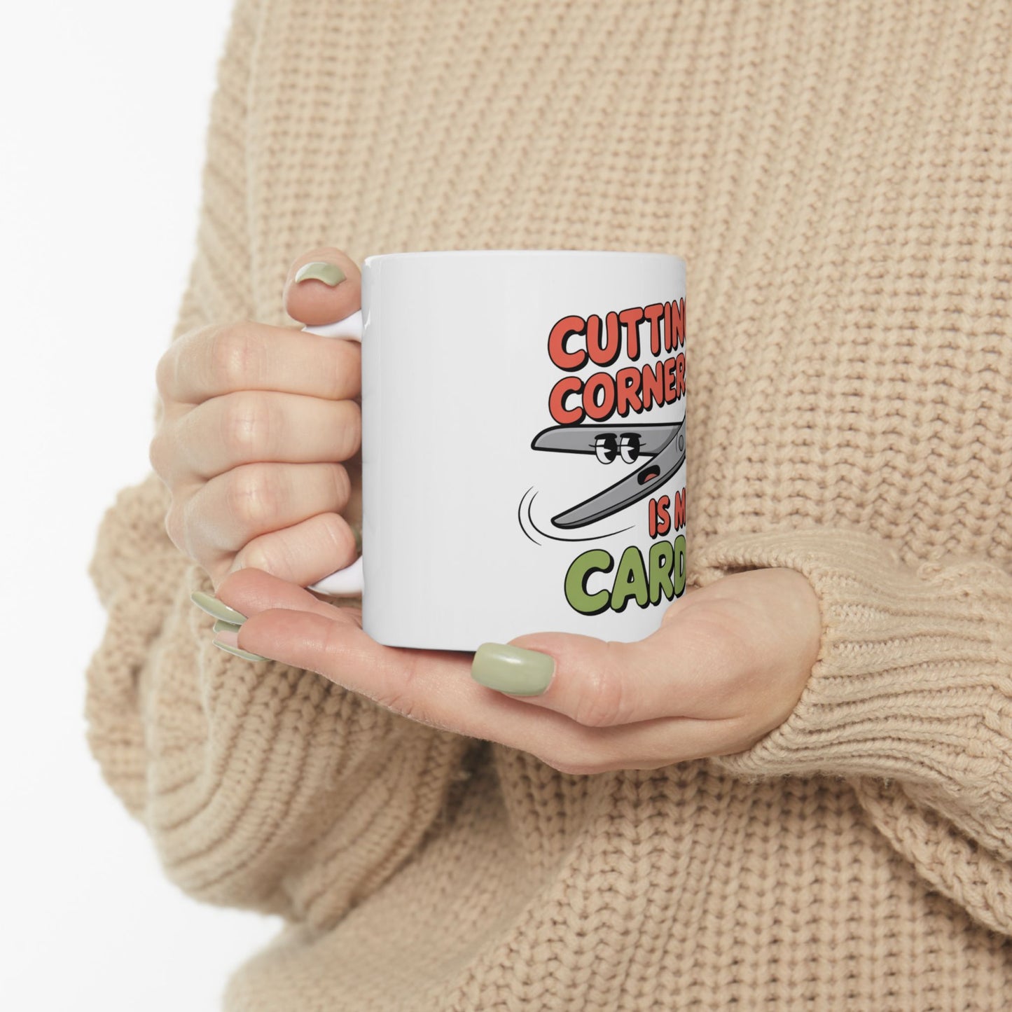 White mug with scissors and text "CUTTING CORNERS IS NO CARTOON".