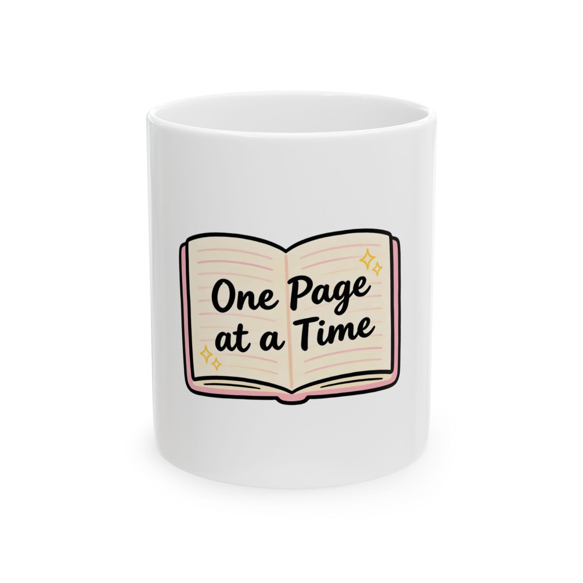 White mug with cartoon book illustration and text "One Page at a Time".
