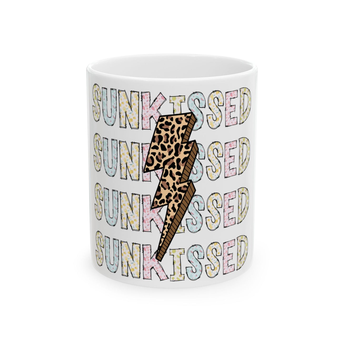 White mug with "SUNKISSED" repeated in pastel colors and leopard print lightning bolt.