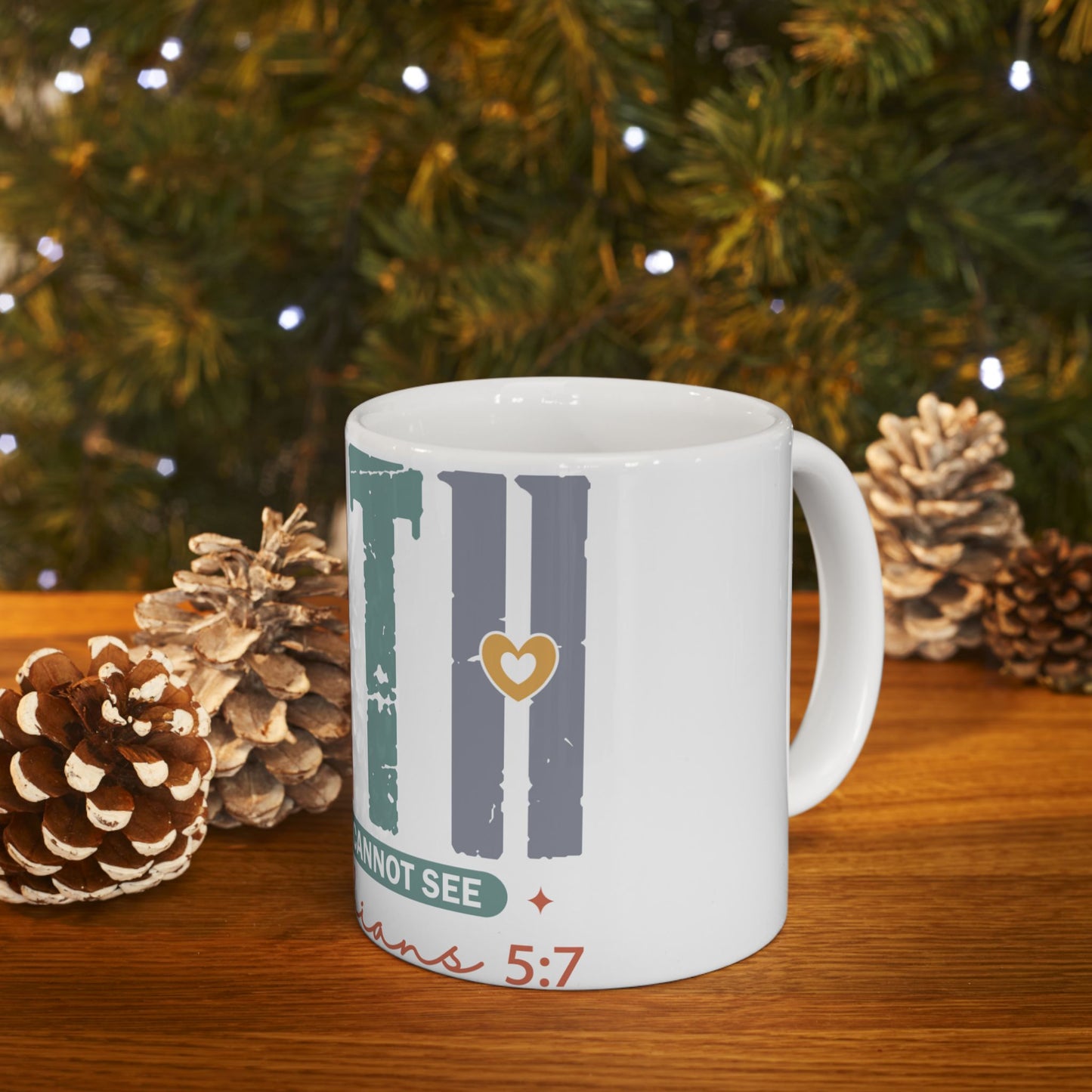 White mug with "FAITH" text, gold heart, and Bible verse, on a wooden surface.