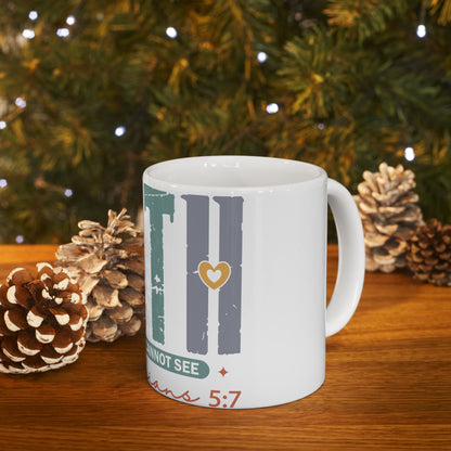 White mug with "FAITH" text, gold heart, and Bible verse, on a wooden surface.