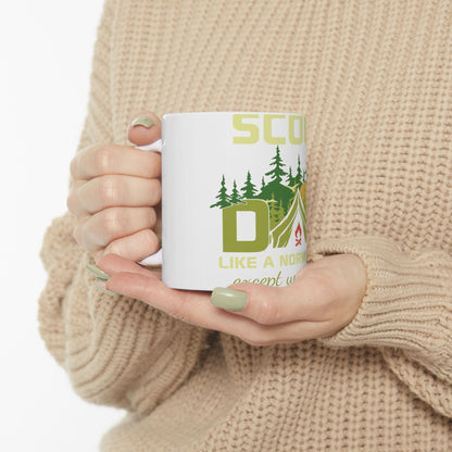 White mug with "SCOUT LIKE A NORM EXCEPT WE CAMP" and camping graphics.