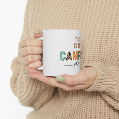 White mug with "This is my camp shirt" text and colorful leopard print letters.