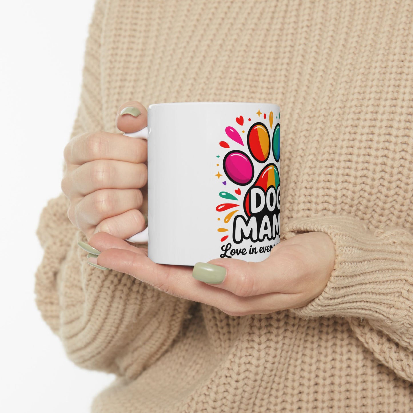 White mug with "Dog Mama Love in Every Paw" and colorful paw print design.