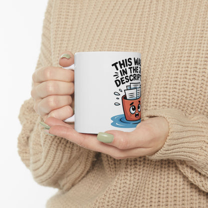 White mug with cartoon trash can saying "This was in the descript."