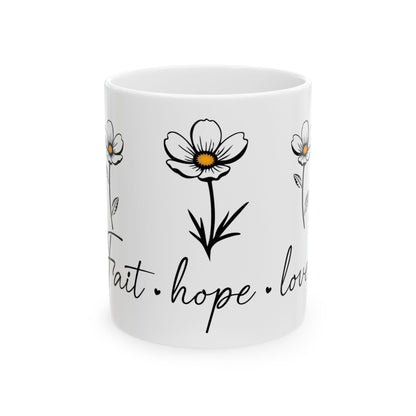White mug with delicate flower art and "faith, hope, love" text.