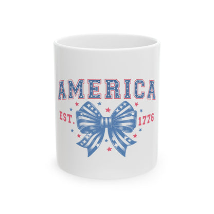 White mug with "AMERICA EST. 1776" and a patriotic ribbon graphic.