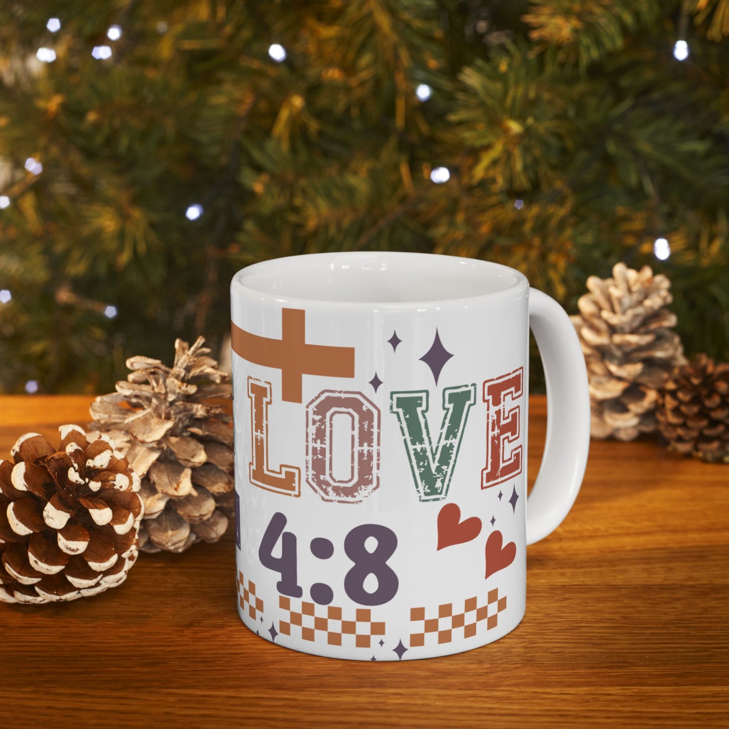 White mug with "LOVE 1:4:8" and hearts, set on a table.