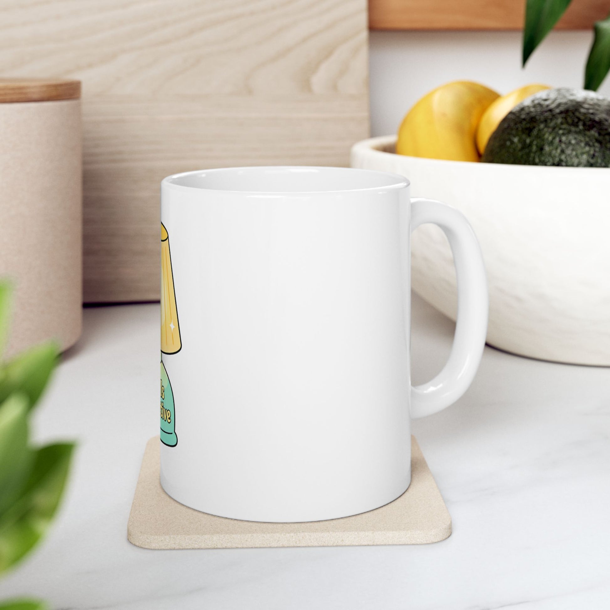 White mug with "This is fine" text and cartoon flame on a coaster.