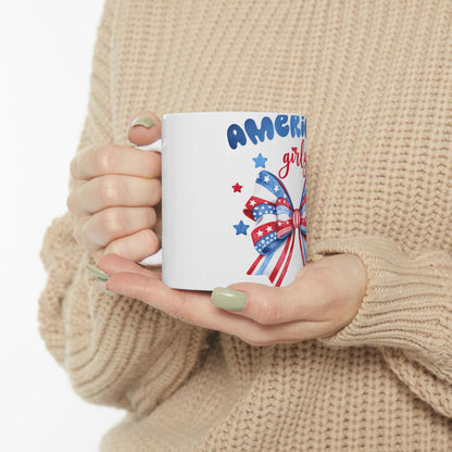 White mug with "Americana girly" text and a red, white, and blue bow.
