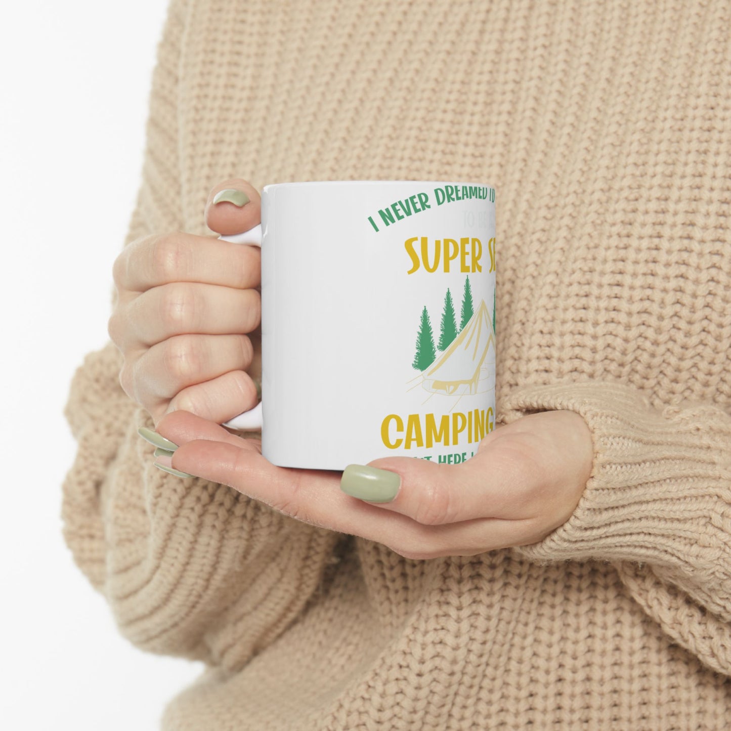 White mug with green text about camping and pine trees.
