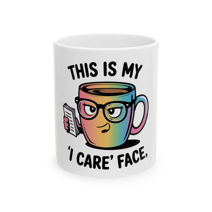 Mug with rainbow gradient, featuring a cartoon coffee cup with glasses and text "THIS IS MY 'I CARE' FACE".