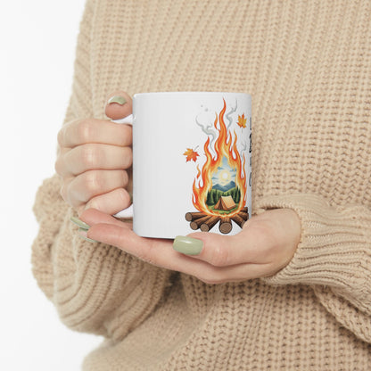 White mug with camping scene and text "Life is better outdoors" held by person.