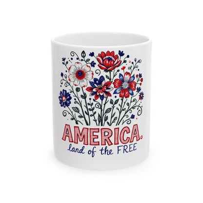 White mug with red, white, and blue floral design and "America, land of the free".