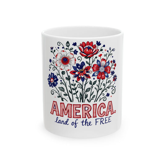White mug with red, white, and blue floral design and "America, land of the free".