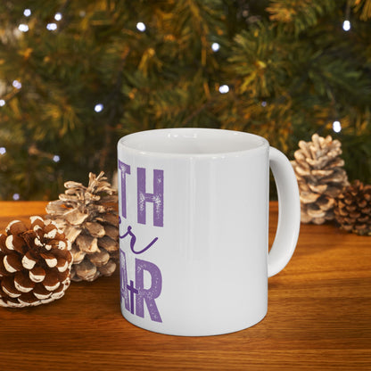 White mug with "Merry & Bright" text on a wooden table.