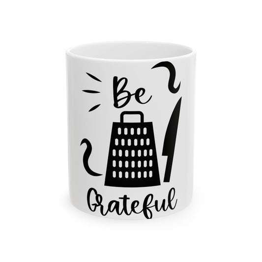 White mug with "Be Grateful" and grater and knife graphics.