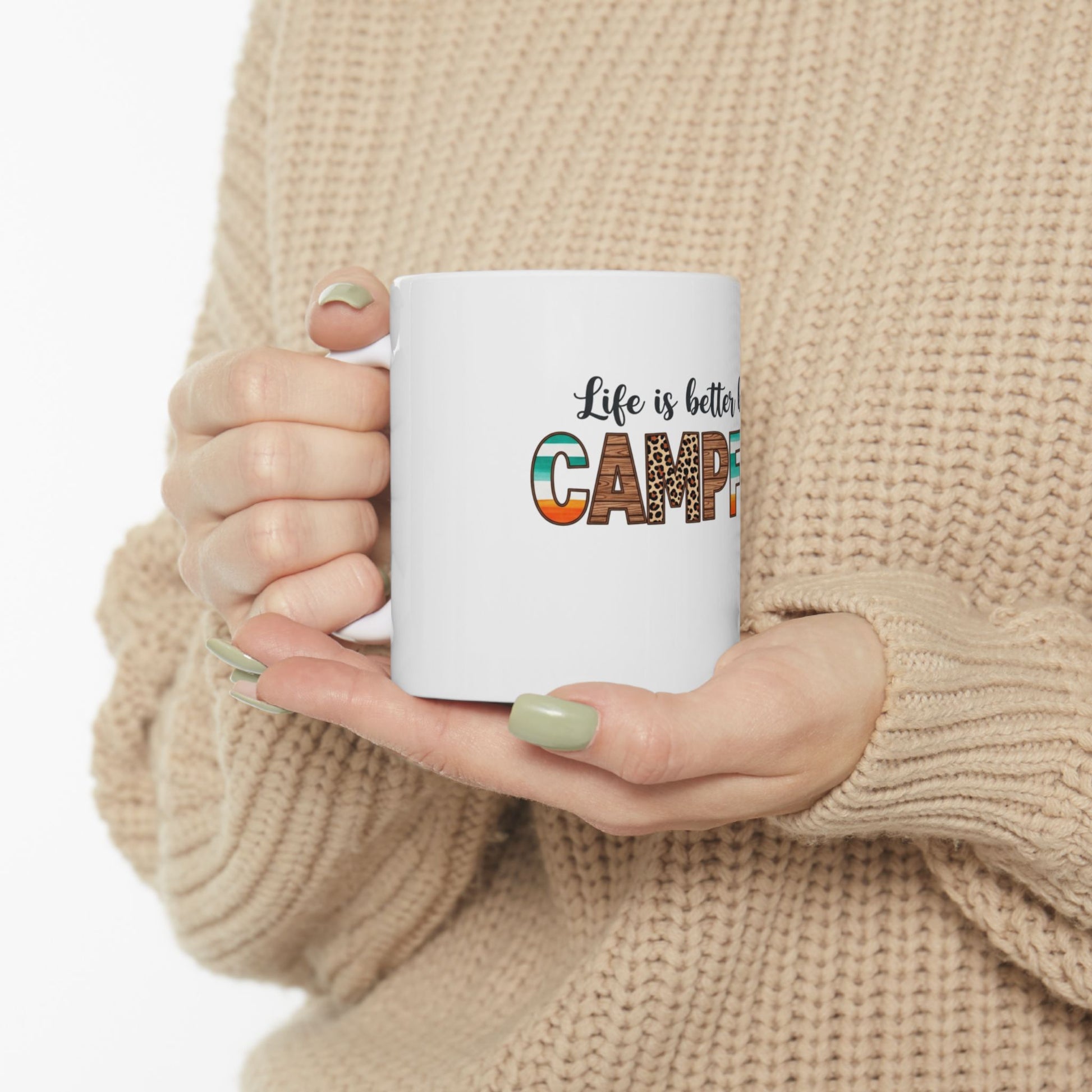 White mug with "Life is better camping" text and leopard print design.