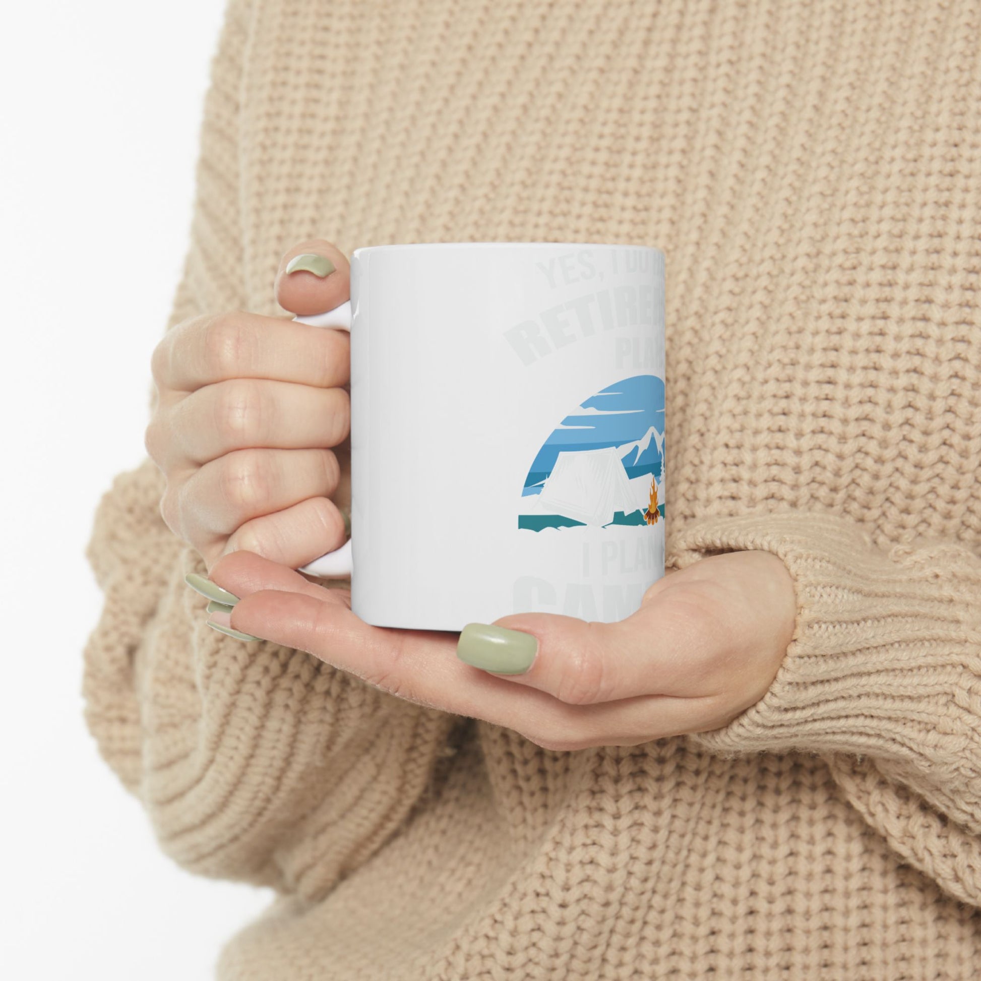 White mug with "Yes, I plan to retire and camp" text and mountain graphic.