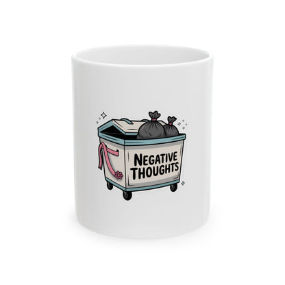 White mug with cartoon dumpster labeled "NEGATIVE THOUGHTS" full of trash bags.
