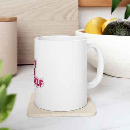 White mug with pink text "start your self" on a coaster.